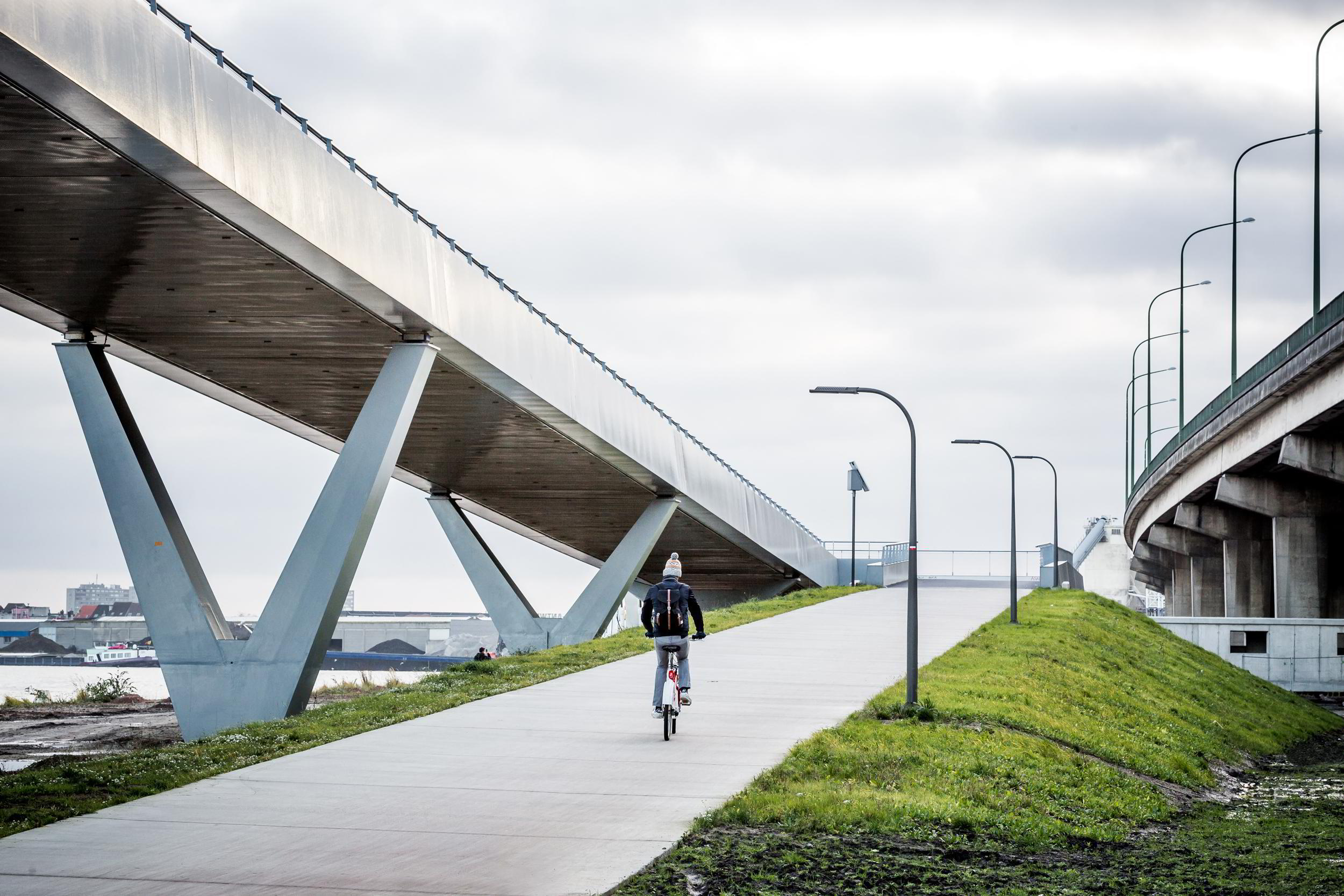 Aanloophelling van de fietsbrug aan de kant van de stad.