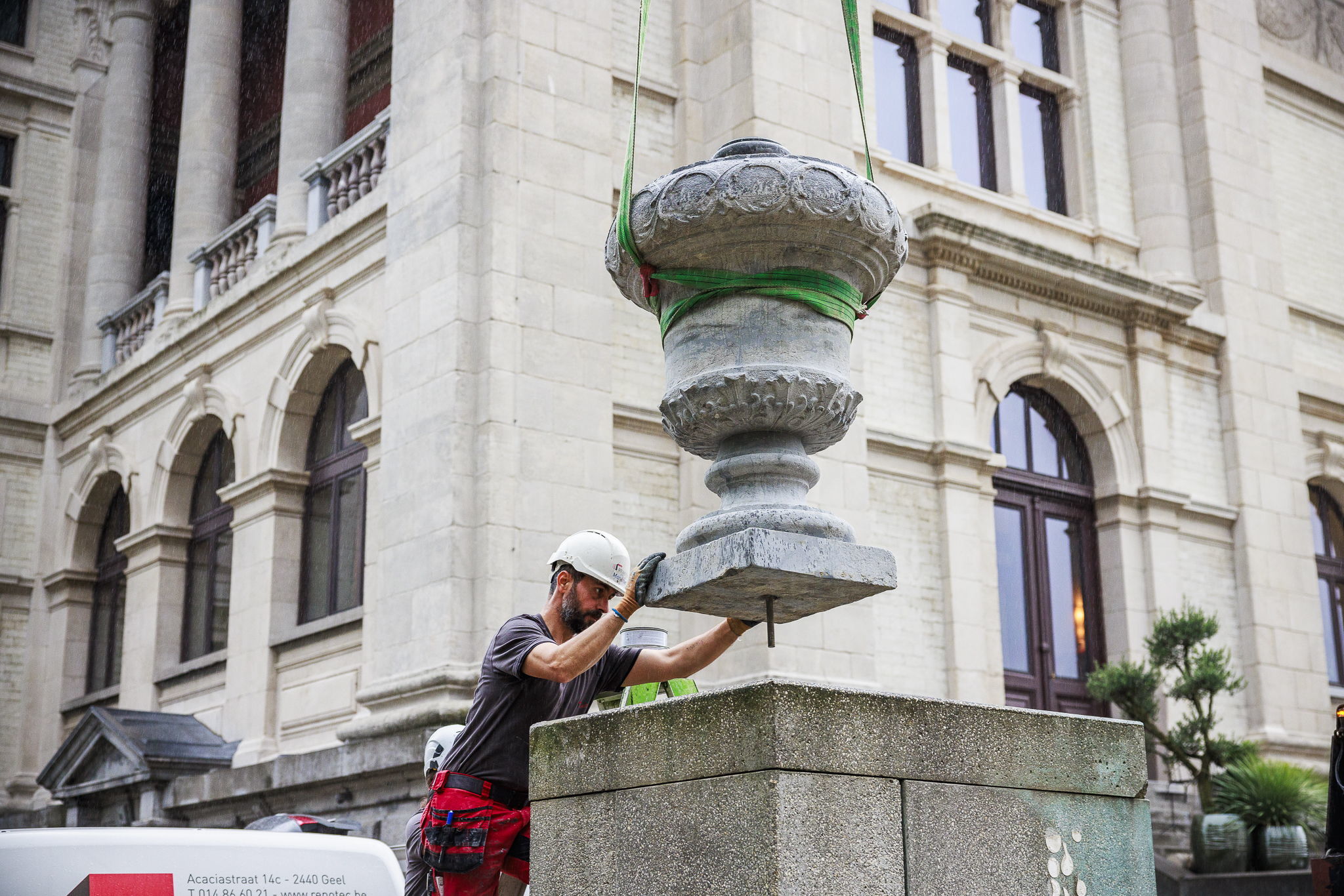 De siervaas wordt vakkundig op de sokkel voor het KMSKA geplaatst.